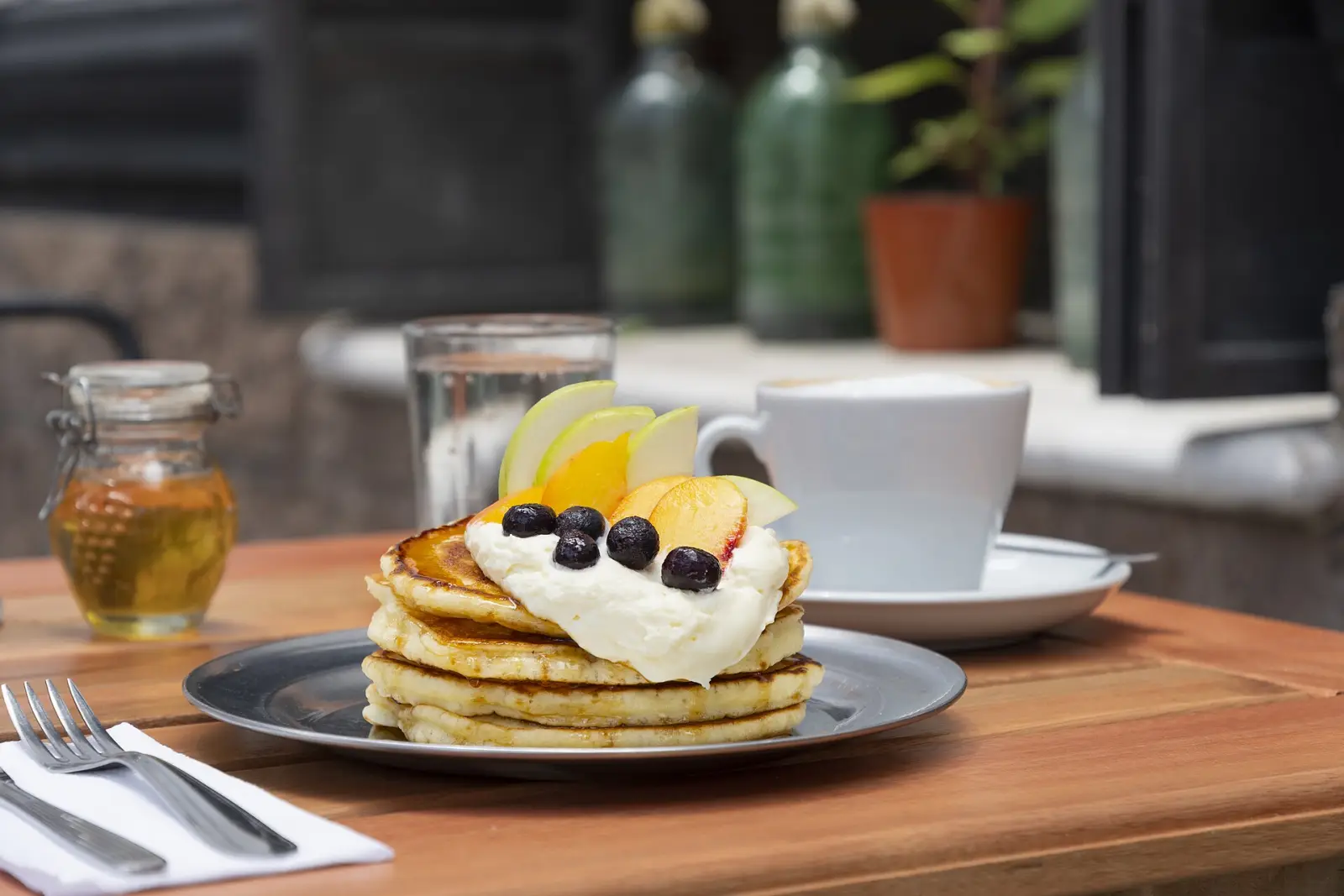 Pancakes and coffee on a cafe table. The photo was not taken at a Johns Creek restaurant.