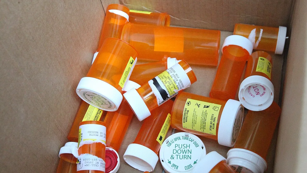 Empty prescription bottles in a collection box at a drug take-back event. The picture was not taken in Johns Creek.