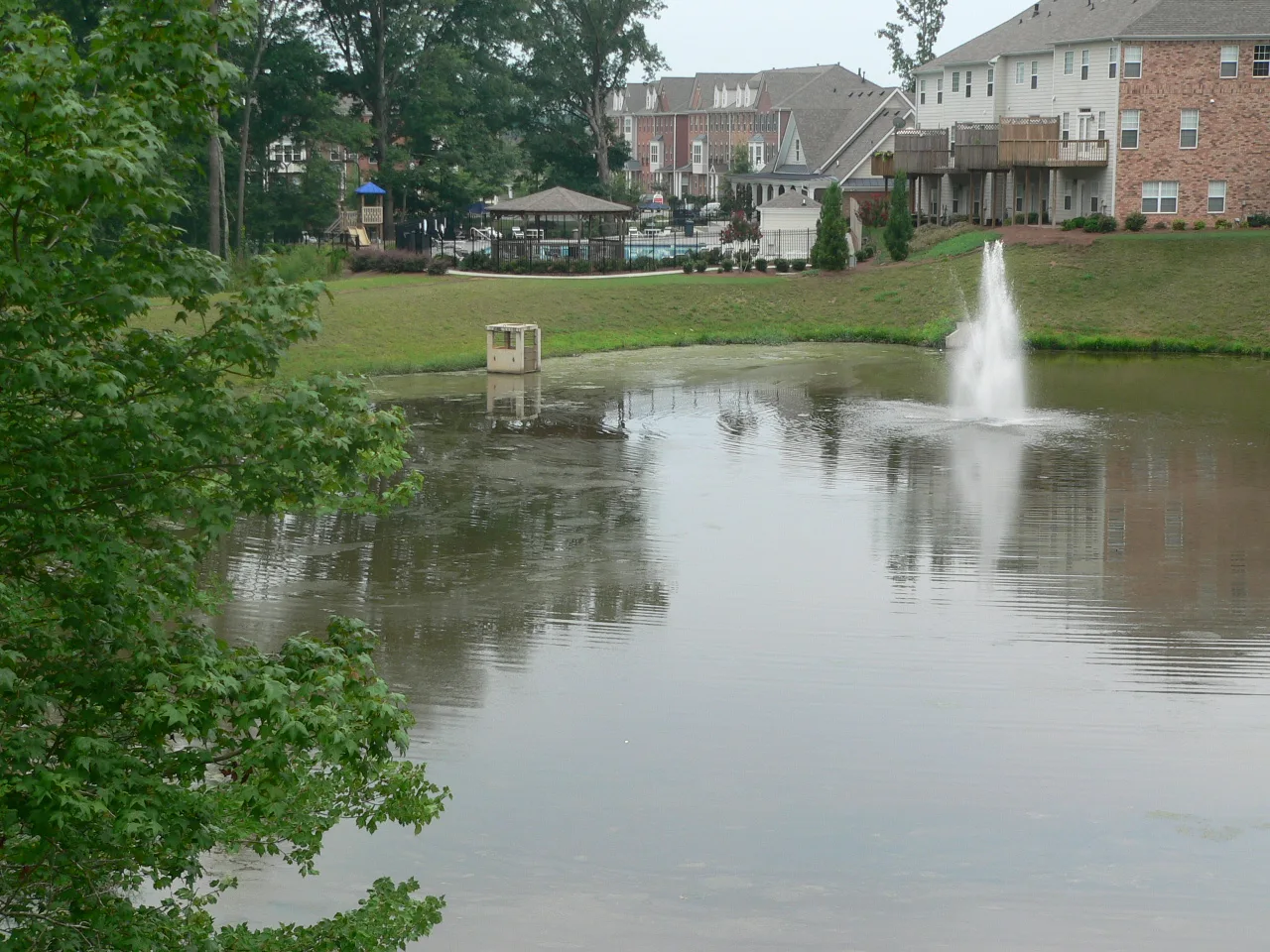 A pond with a fountain in a Johns Creek neighborhood a little over half a mile north of the school