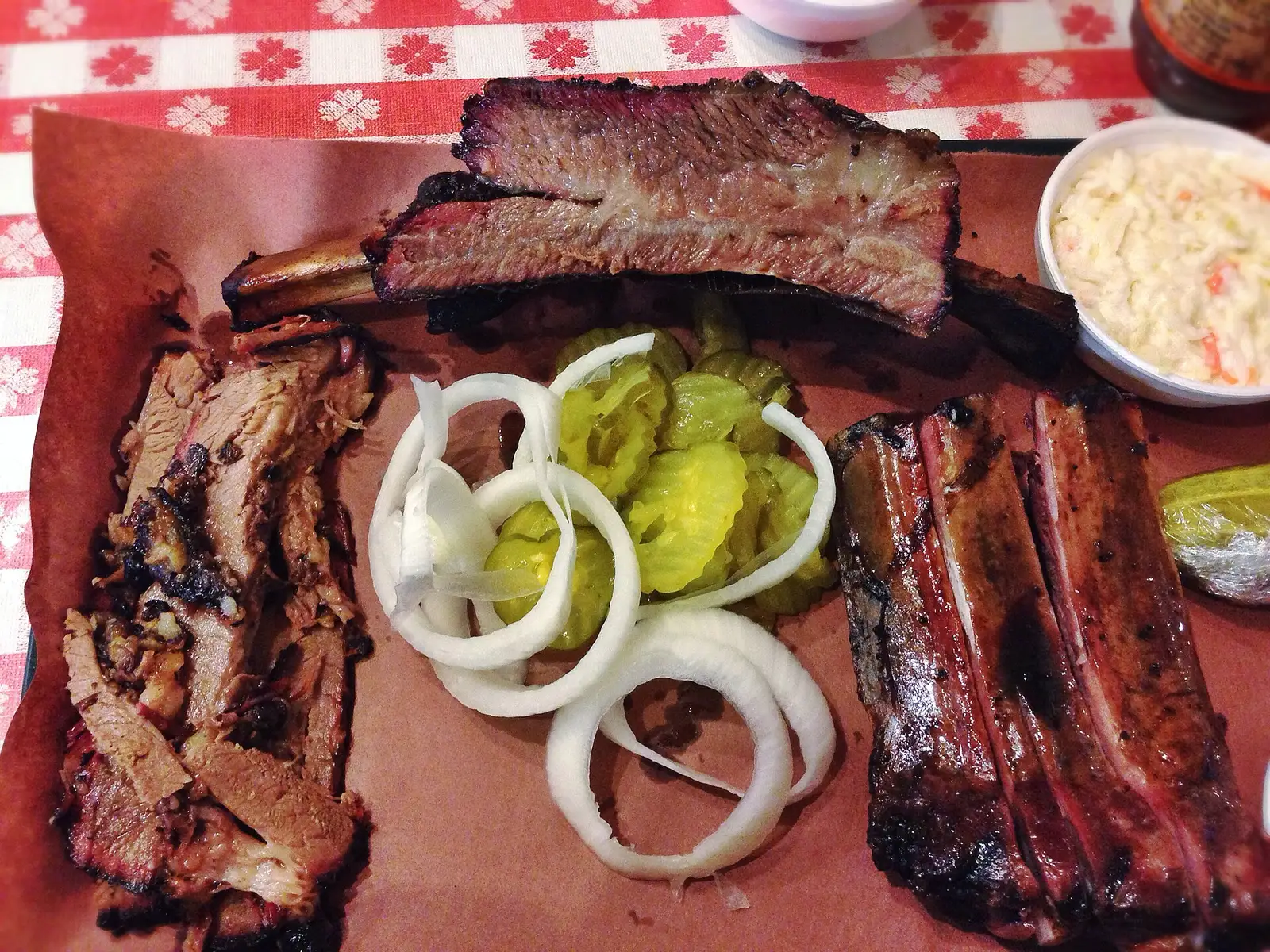A barbecue plate of brisket, beef rib and pork ribs. The photo was not taken at a Johns Creek restaurant.